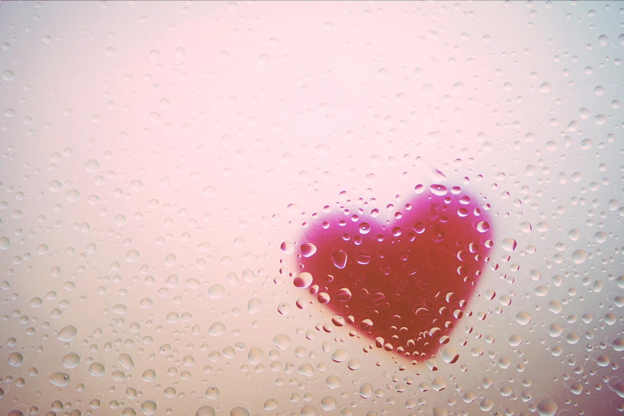 A red heart covered in raindrops
