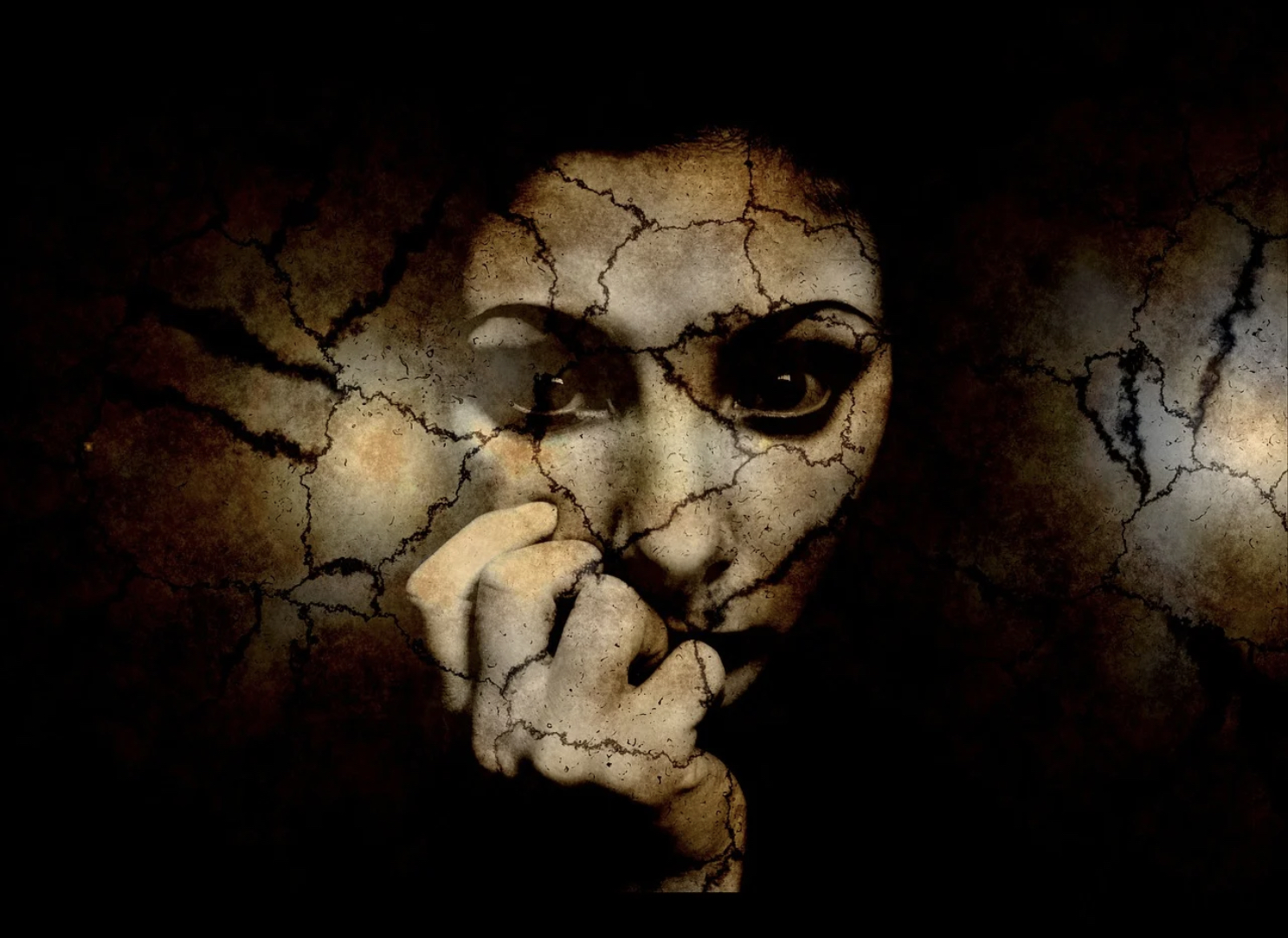 A woman's face, cracked and broken.