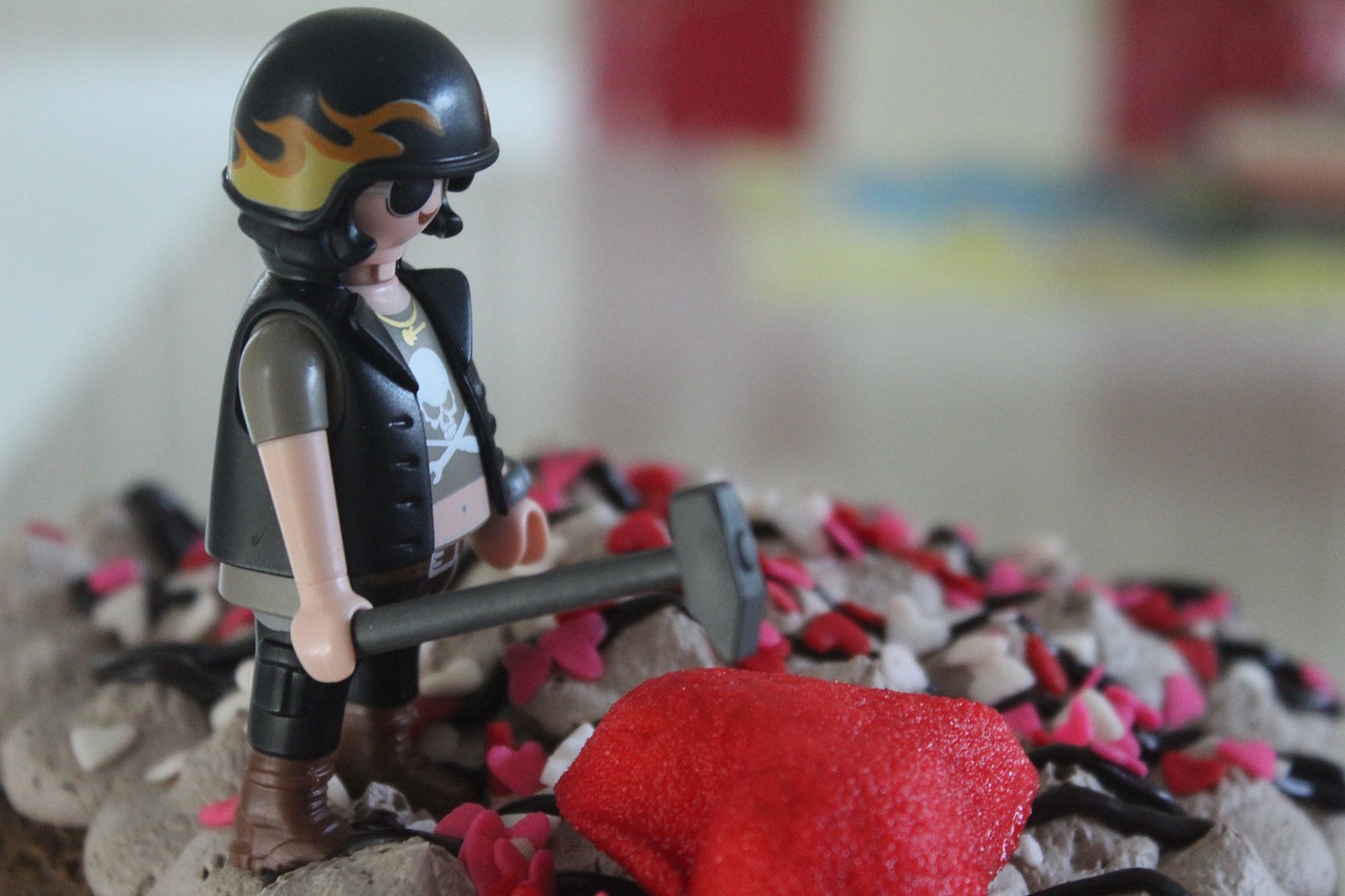 A lego biker smashing a red heart with an axe.